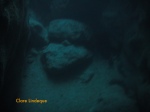 Rocks on the seafloor in the darkness of the tunnel